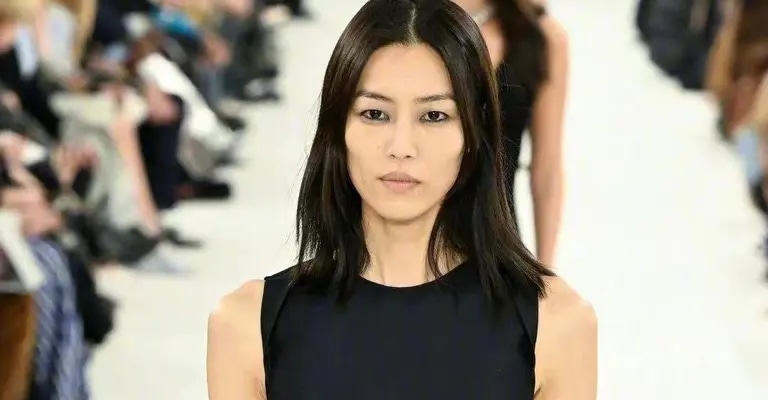 Nữ siêu mẫu trở thành "Nữ hoàng bóng đêm" sải bước đầy tự tin trong set all black đầm maxi đen sát nách mix cùng găng tay và túi xách tiệp màu.